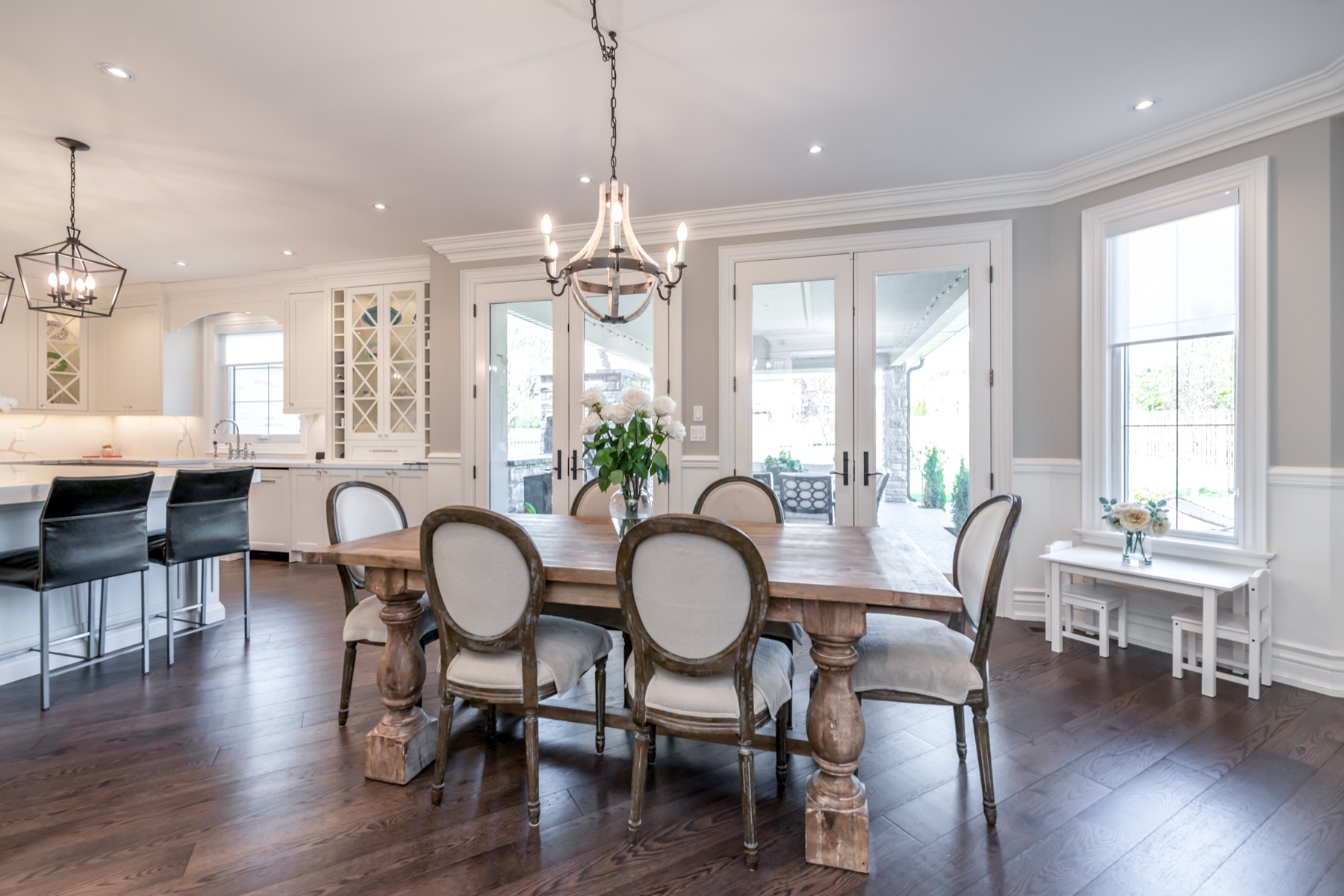 Dining room with rustic trestle table and wrought-iron chandelier