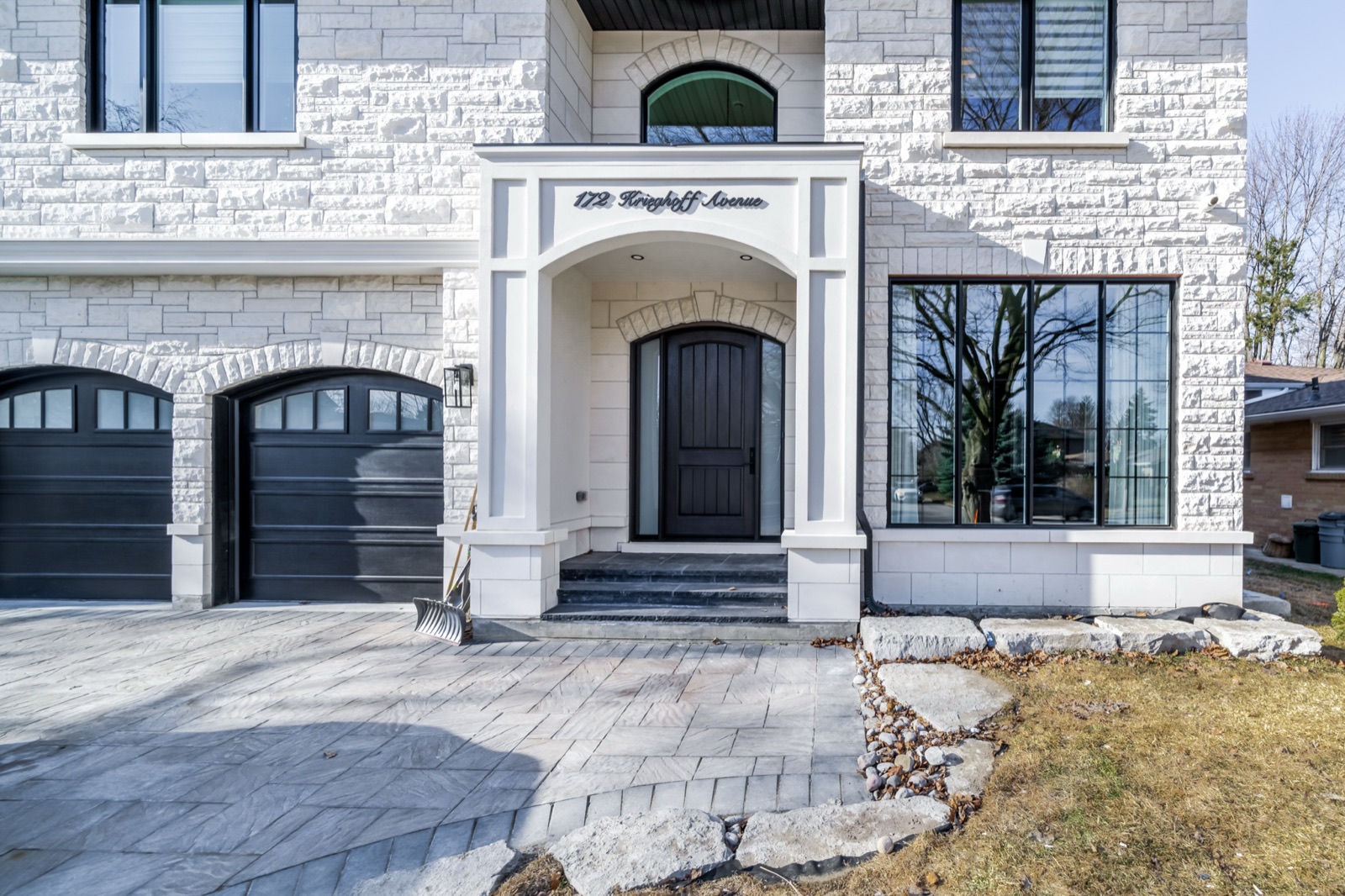 White stone estate entrance with columned portico