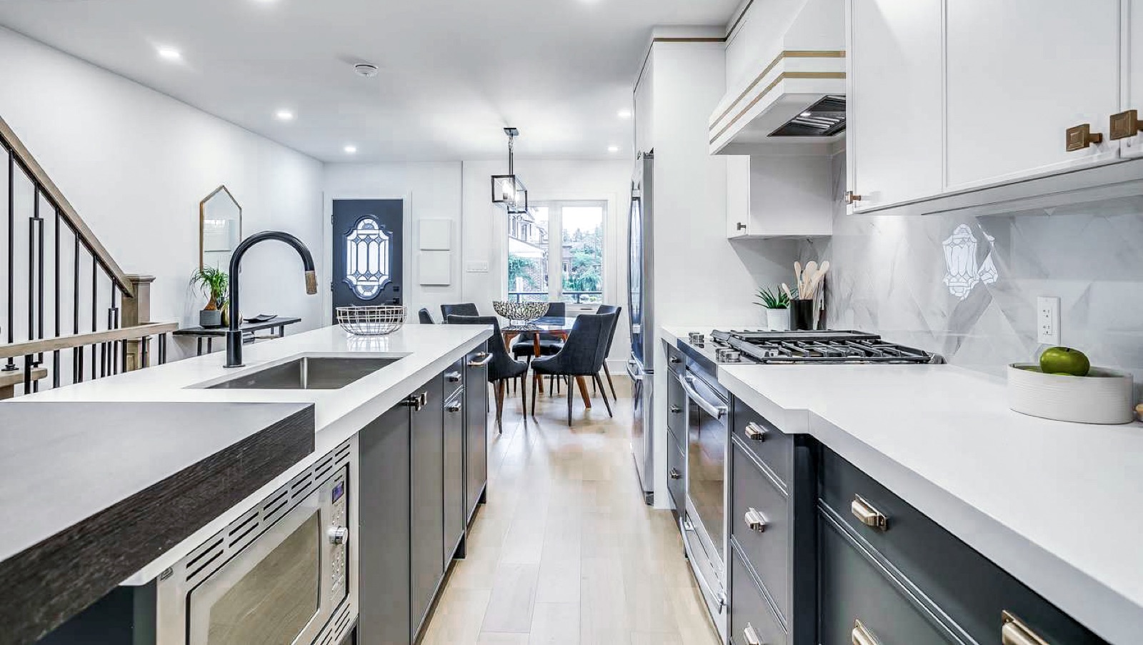 Navy galley kitchen with integrated appliances and quartz counters