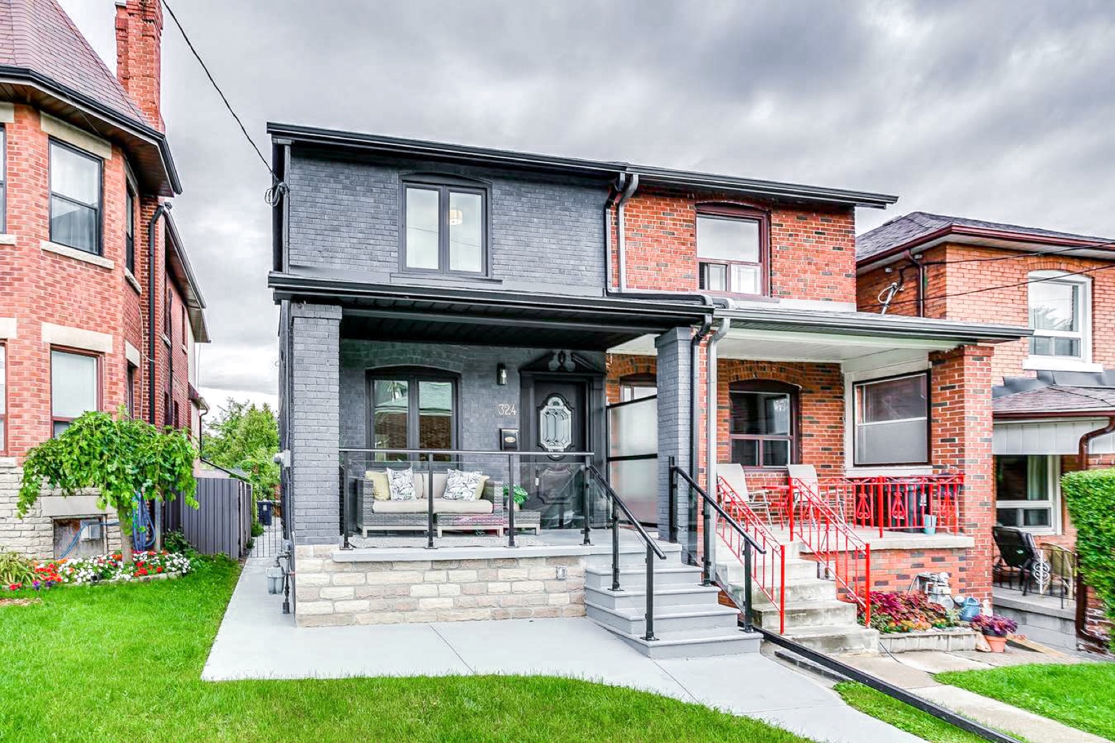 Dark brick Toronto home with rebuilt modern porch